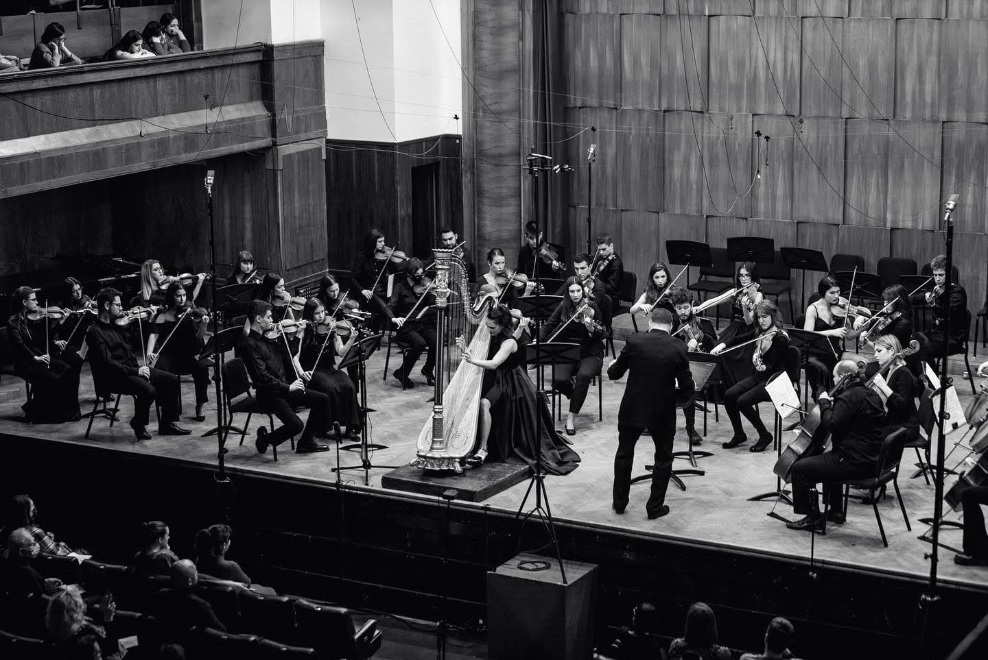 Irina performing solo on stage in a concert setting